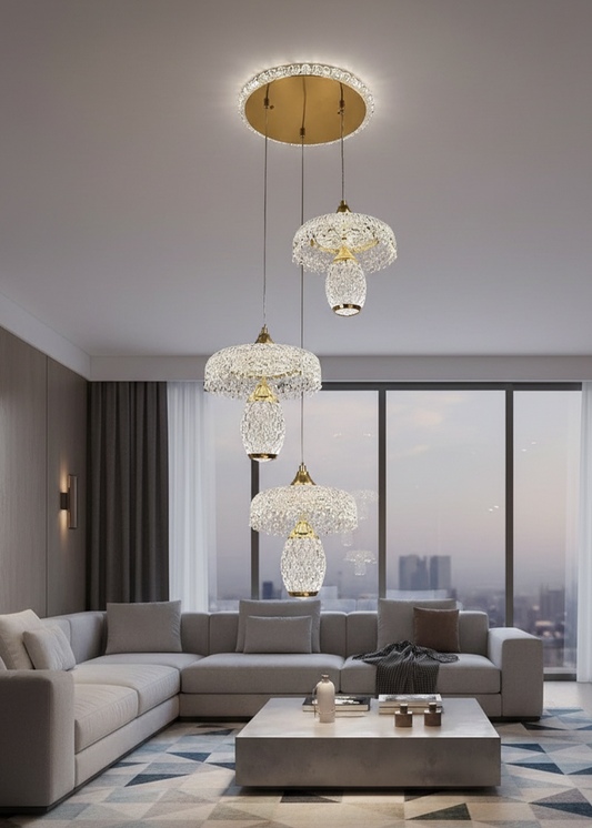 Swanart modern crystal pendant chandelier with three gold-finish LED lights, hanging over a dining table or staircase.