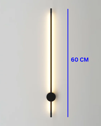 Modern Swanart LED wall sconce in black and gold with warm white ambient light, used as a decorative indoor lamp in living rooms or hallways.
