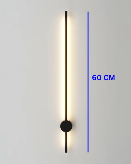Modern Swanart LED wall sconce in black and gold with warm white ambient light, used as a decorative indoor lamp in living rooms or hallways.