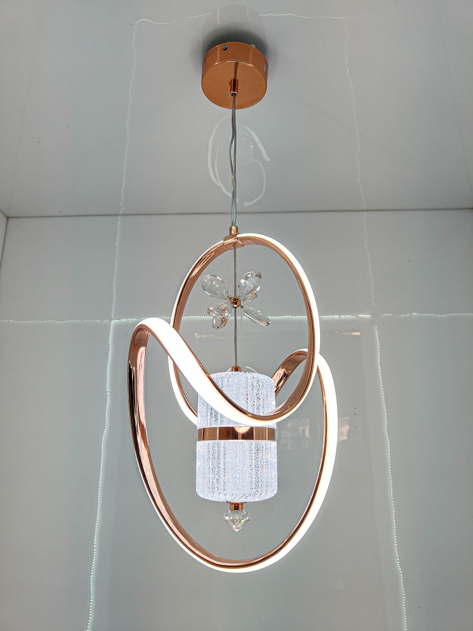 Modern Swanart crystal LED pendant light with rose gold rings, adjustable height, decorative ceiling lamp for living room or bedroom.