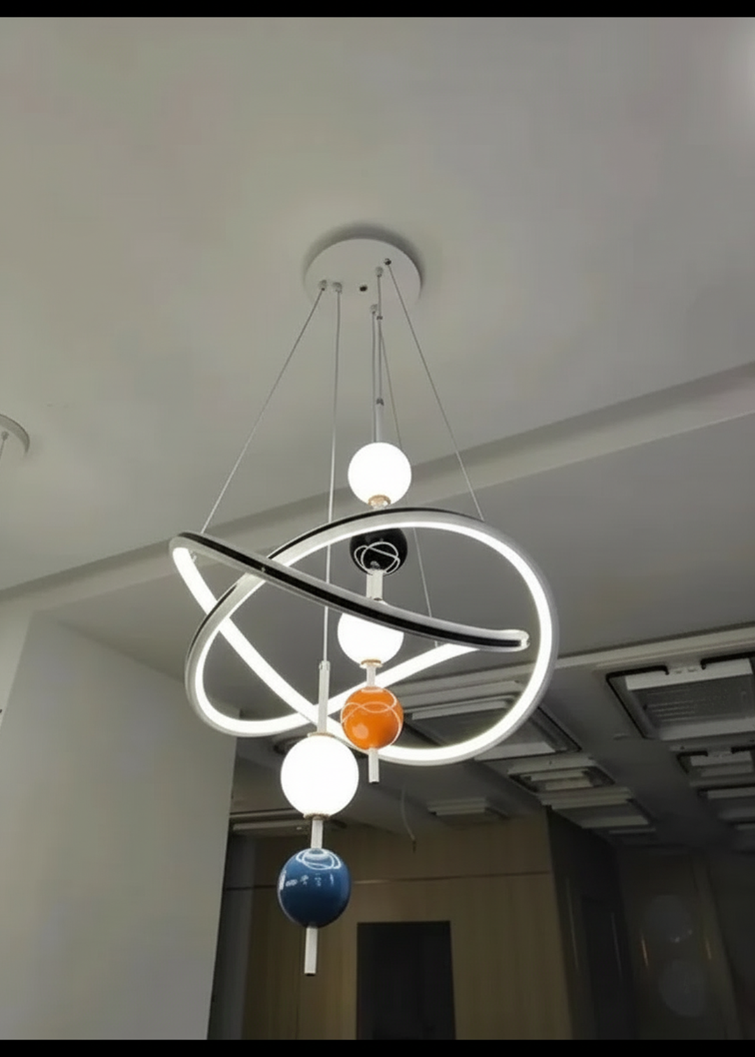 Modern Swanart hanging light fixture with a sleek design, showcasing a contemporary chandelier in a stylish interior setting.