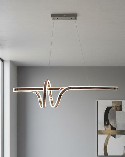 Swanart modern LED wave pendant chandelier hanging over a dining table, artistic linear ceiling light for contemporary living room decor.
