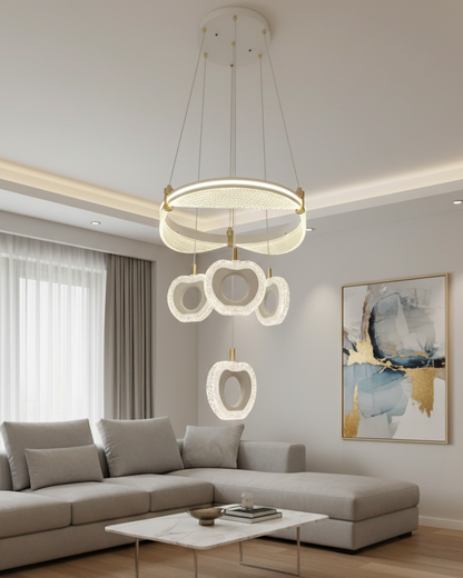 Swanart modern LED ring chandelier with crystal flower pendant lights hanging from ceiling in a stylish living room setting