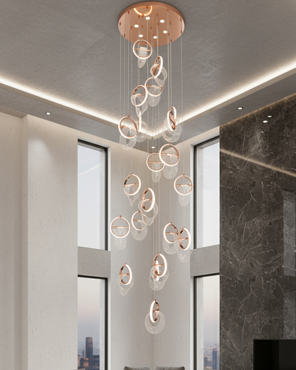 Swanart modern crystal ring chandelier in rose gold with LED lights, hanging from ceiling in a stylish living room setting.