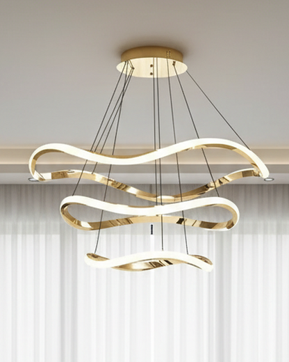 Swanart modern LED hanging pendant light with wave design, gold finish, 3-color dimmable LED ceiling fixture in a contemporary living room setting.