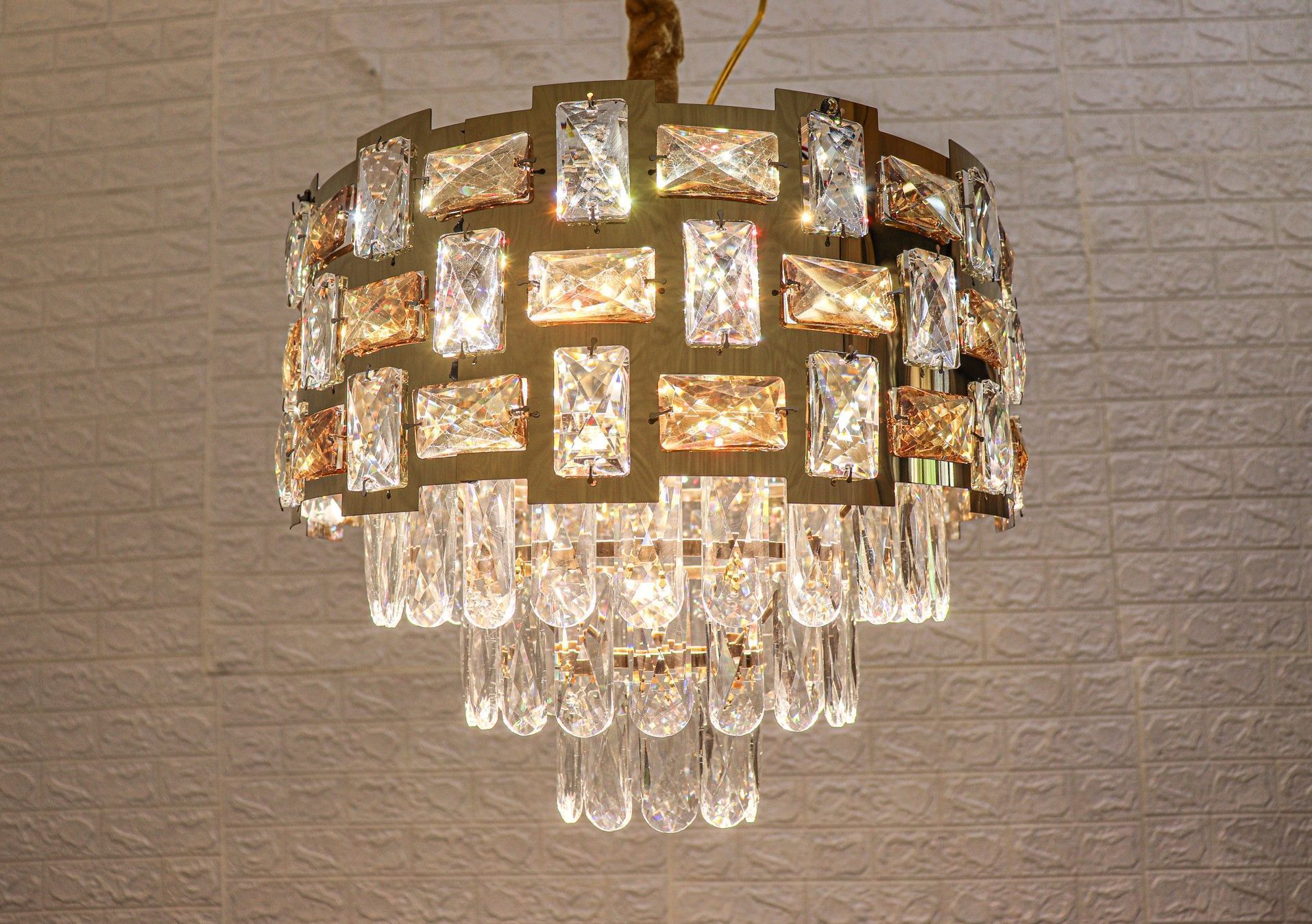 Swanart Dazzling Cascade 3-tier crystal pendant light with sparkling glass droplets hanging from a metal frame.
