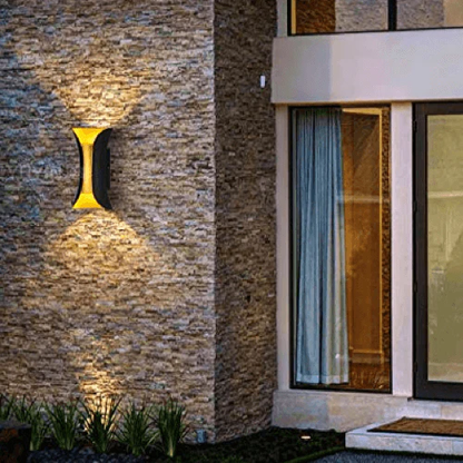 Elegant black and gold Swanart LED wall light with modern design, mounted on a facade, showcasing stylish illumination.